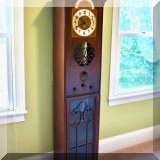 D06. Falcon grandmother clock with built in radio. 70”h x 15”w x 11”d 